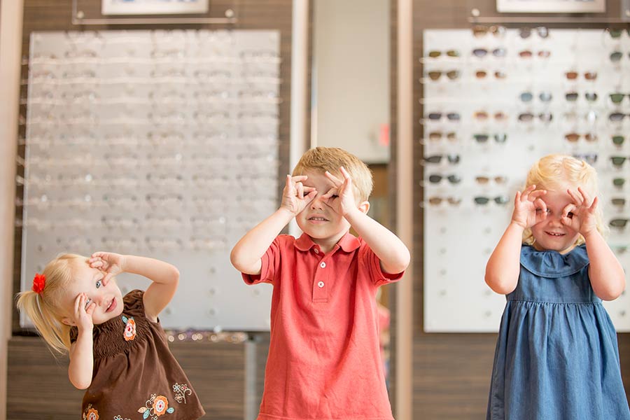 Man in a suit trying on glasses