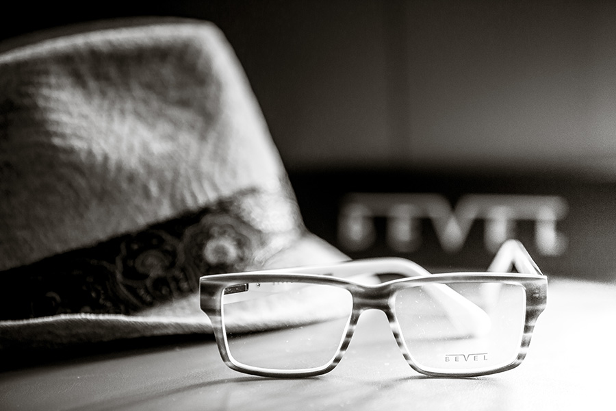 Man in a suit trying on glasses