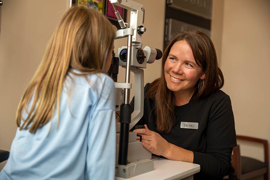 Eye doctor with young patient